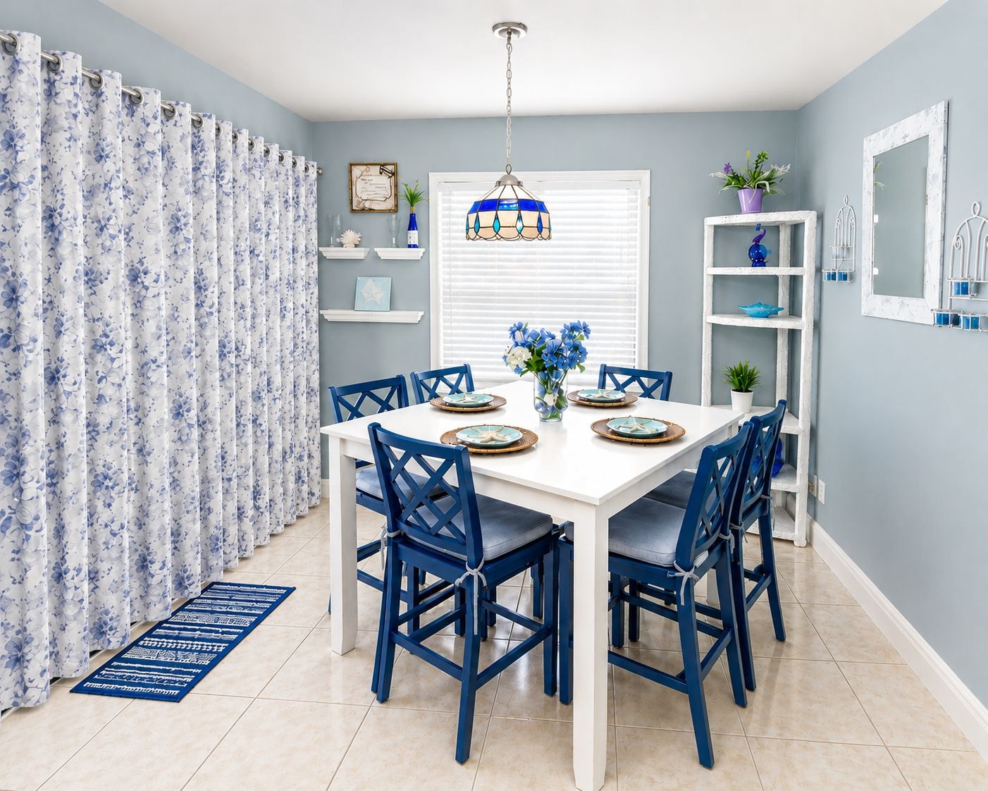 Unit 204 dining room with blue chairs and floral curtains