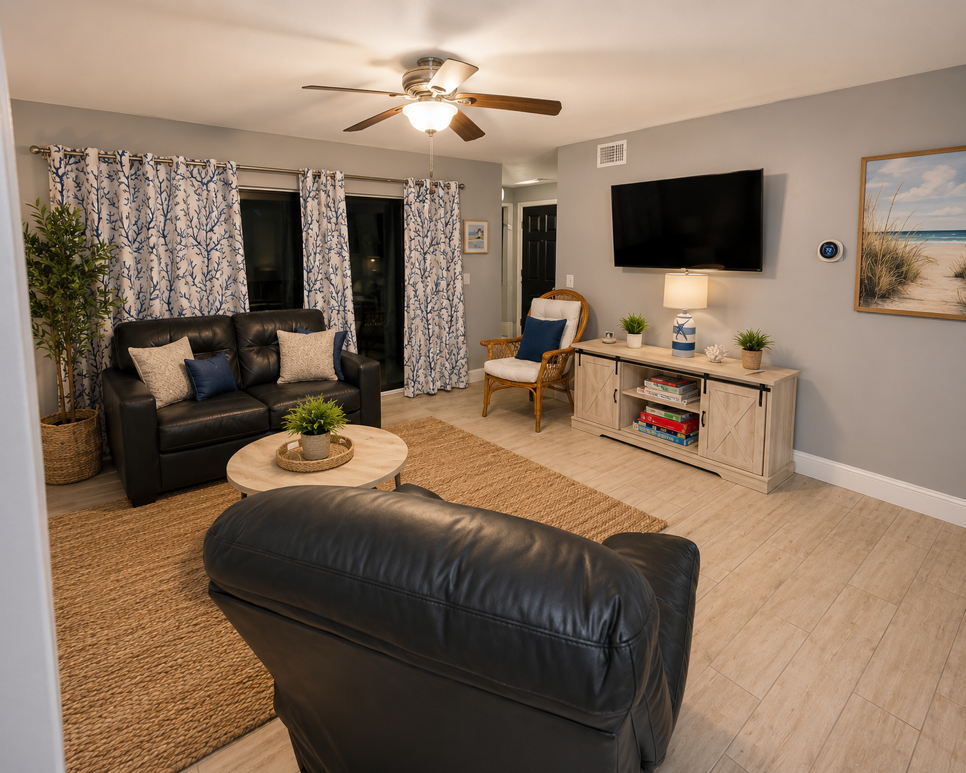 Unit 204 living room with coral-print curtains
