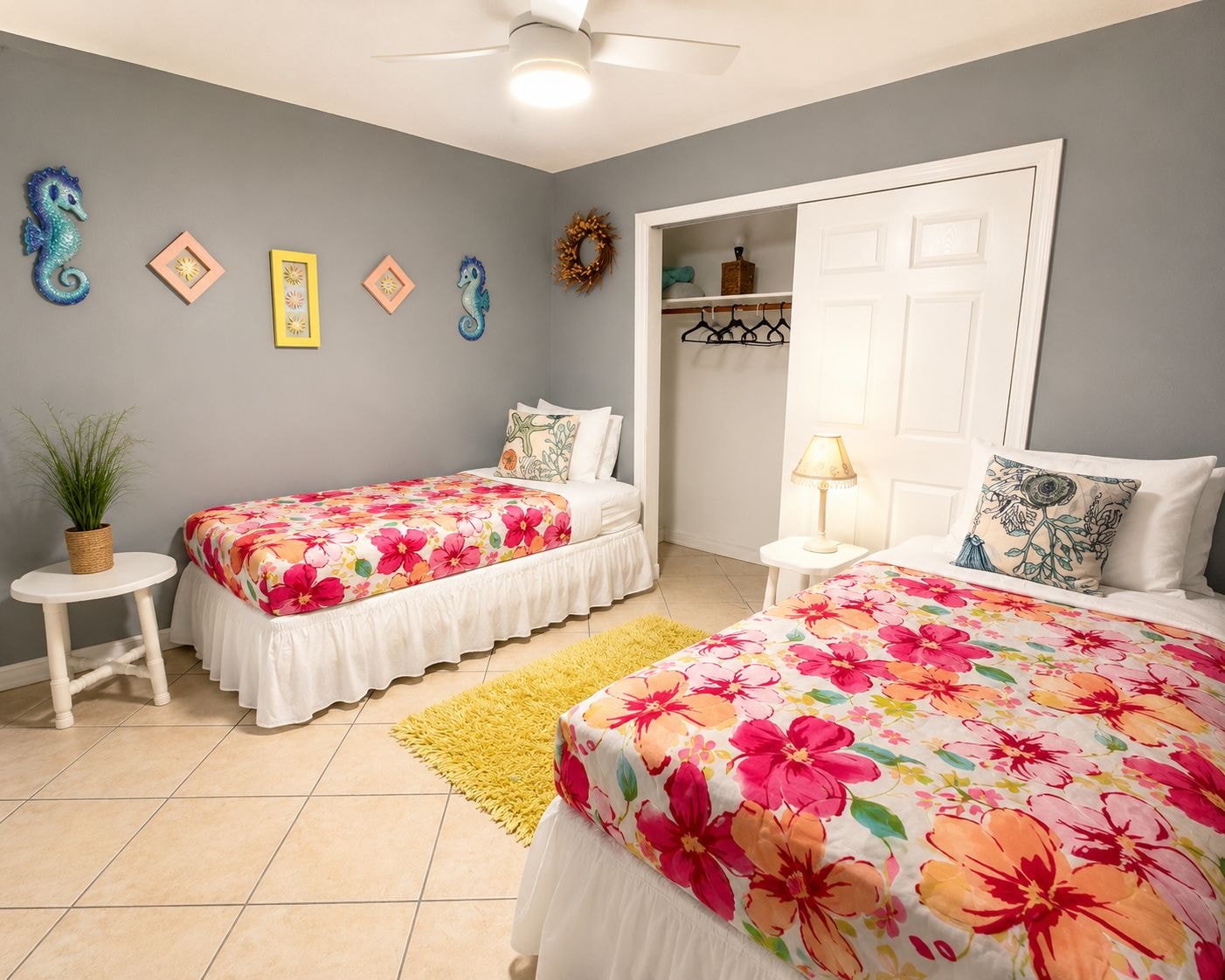 Unit 204 twin bedroom with floral bedding and seahorse decor